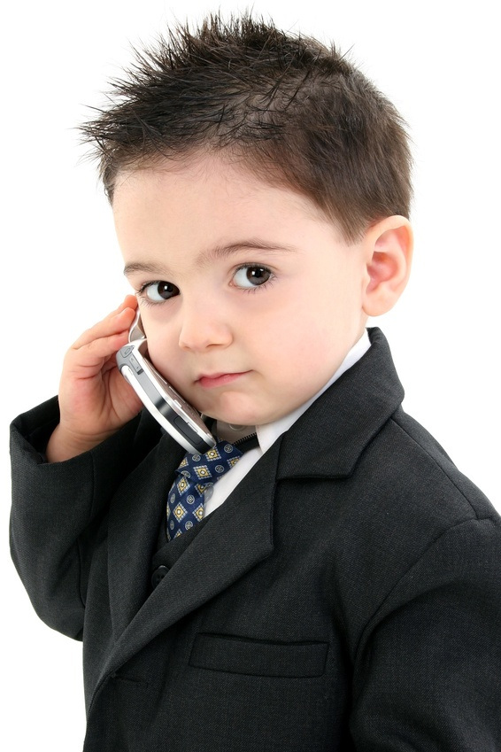 adorable baby boy in suit on cellphone