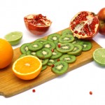 Board with cut fresh fruits
