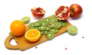 Board with cut fresh fruits