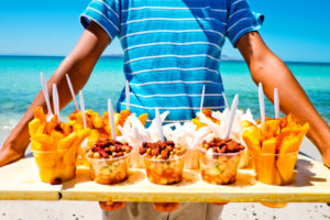ECJ93Y A boy sells fruit on Tecelote Beach in La Paz, Mexico.